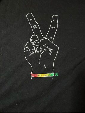 Black Graphic Tee with White Peace Hand and Rainbow Bracelet